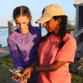 Saria showing Vivien how to hold and not get pinched